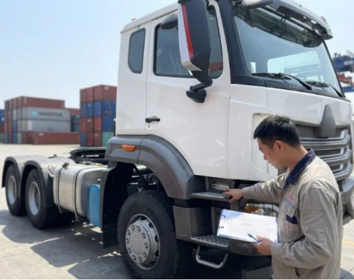 Inspector checking a refurbished tractor truck with a professional checklist.