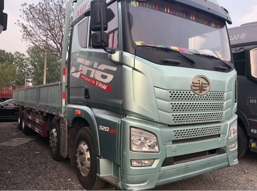Light green used FAW flatbed truck parked outdoors