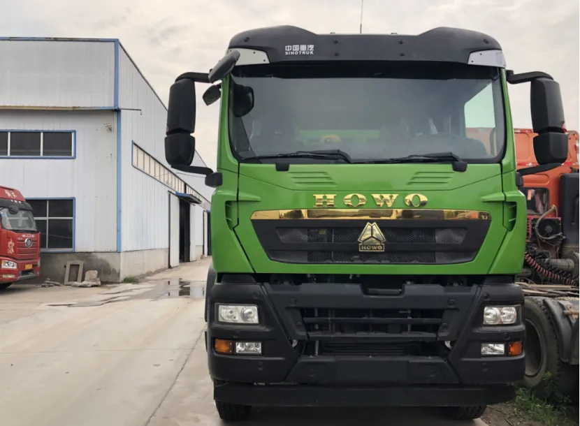 Front view of a green HOWO Sinotruk truck parked in an industrial area
