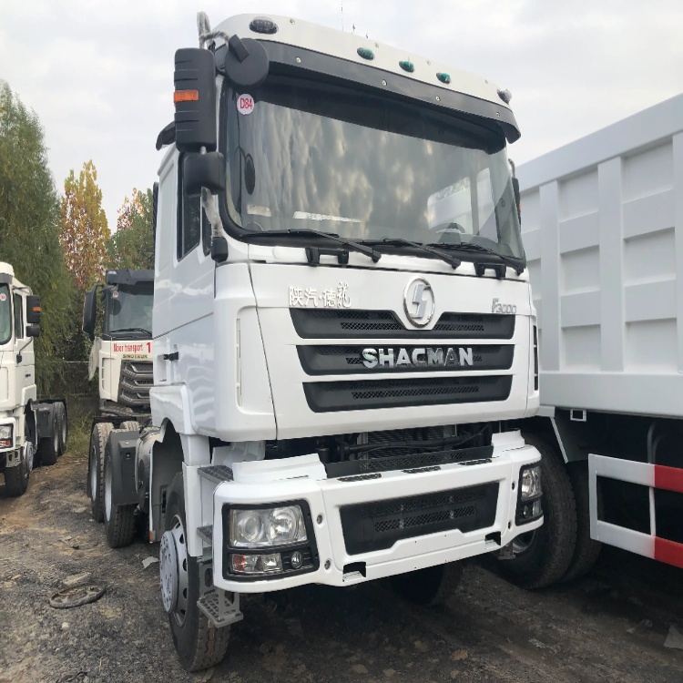 Front view of a white SHACMAN F3000 heavy-duty tractor truck parked outdoors